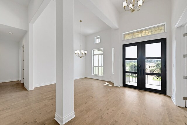 905 Crestone Stream Dr, Austin, TX 78738 - foyer featuring a chandelier, a high ceiling, wood finished floors, and french doors