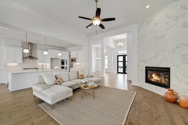 905 Crestone Stream Dr, Austin, TX 78738 - living area with wood finished floors, recessed lighting, ceiling fan, and a fireplace