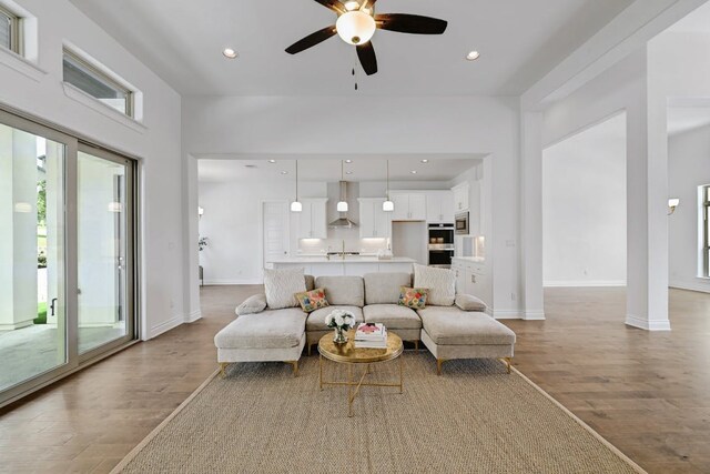905 Crestone Stream Dr, Austin, TX 78738 - living area with light wood-style flooring, a ceiling fan, and recessed lighting