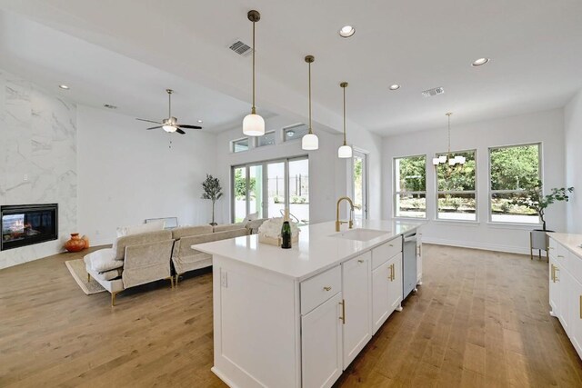 905 Crestone Stream Dr, Austin, TX 78738 - kitchen with light wood-style flooring, recessed lighting, white cabinets, and light countertops