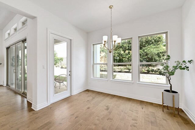905 Crestone Stream Dr, Austin, TX 78738 - unfurnished dining area with a chandelier and wood finished floors