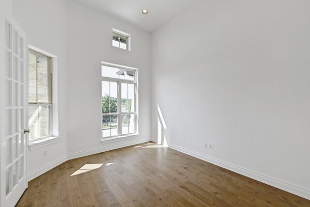 905 Crestone Stream Dr, Austin, TX 78738 - unfurnished room with wood finished floors and a high ceiling