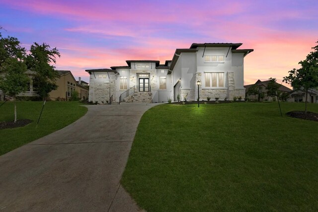 905 Crestone Stream Dr, Austin, TX 78738 - view of front of home featuring stone siding, a front lawn, driveway, and stucco siding