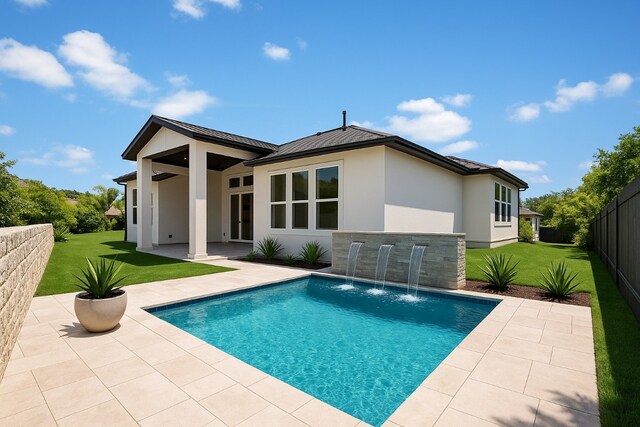 905 Crestone Stream Dr, Austin, TX 78738 - back of property with stucco siding, a patio, a fenced backyard, and a metal roof