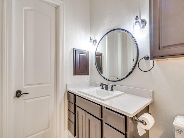 bathroom featuring toilet and vanity