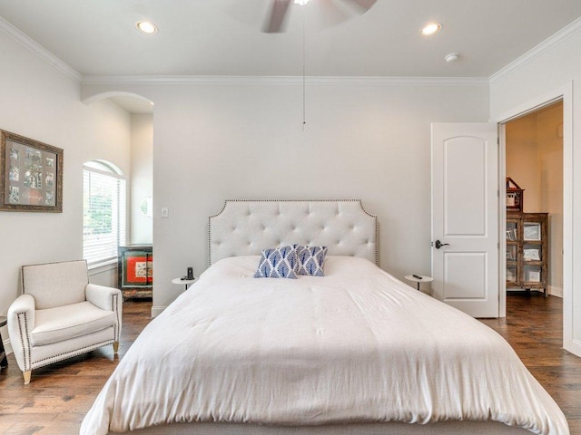 bedroom with a ceiling fan, arched walkways, ornamental molding, dark wood-type flooring, and recessed lighting