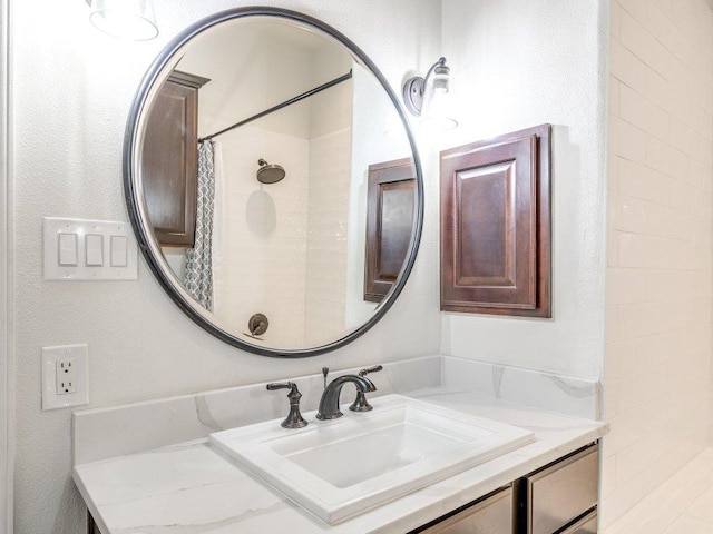 bathroom featuring curtained shower and vanity