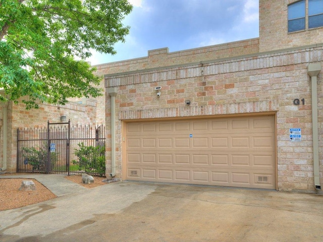 garage with driveway and fence