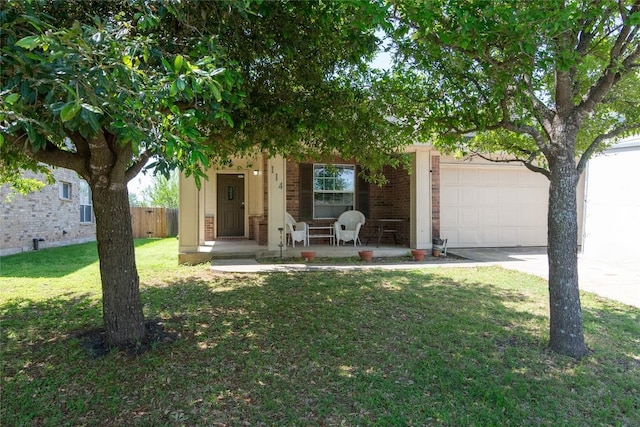 114 Mossy Rock Cv, Hutto, TX 78634 - obstructed view of property with a porch, a garage, driveway, and brick siding