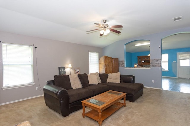 114 Mossy Rock Cv, Hutto, TX 78634 - carpeted living room featuring ceiling fan and arched walkways