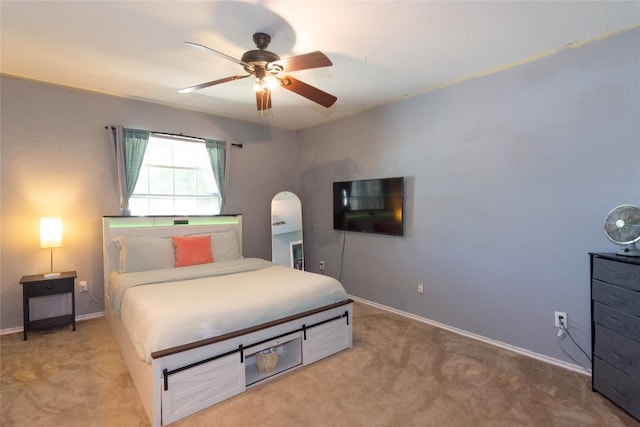 114 Mossy Rock Cv, Hutto, TX 78634 - bedroom featuring light carpet, arched walkways, and ceiling fan