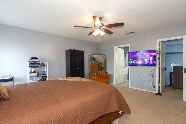 114 Mossy Rock Cv, Hutto, TX 78634 - bedroom with light colored carpet, ensuite bath, and ceiling fan