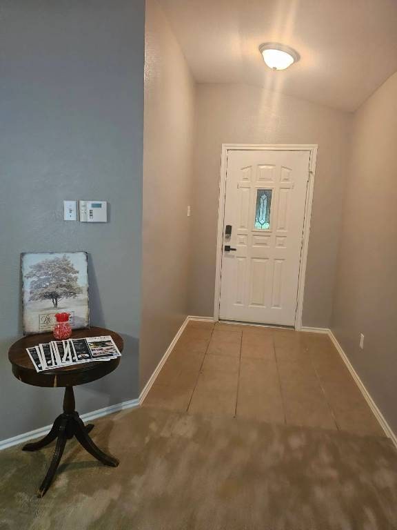 114 Mossy Rock Cv, Hutto, TX 78634 - entryway featuring tile patterned flooring and vaulted ceiling