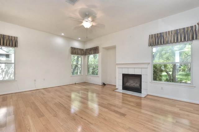 229 Whispering Wind Dr, Georgetown, TX 78633 - unfurnished living room featuring ceiling fan, wood finished floors, and a fireplace