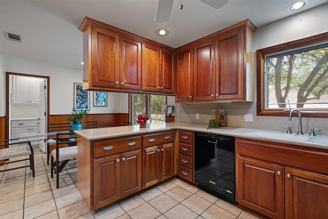 4602 Laurel Canyon Dr, Austin, TX 78731 - kitchen with black dishwasher, light countertops, wainscoting, a peninsula, and ceiling fan