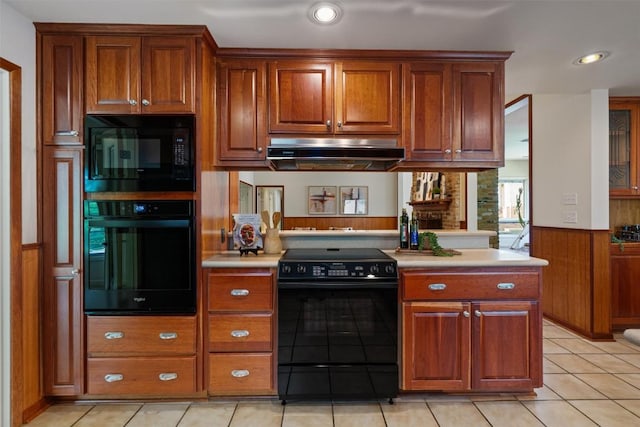 4602 Laurel Canyon Dr, Austin, TX 78731 - kitchen featuring black appliances, range hood, a wainscoted wall, light countertops, and brown cabinets