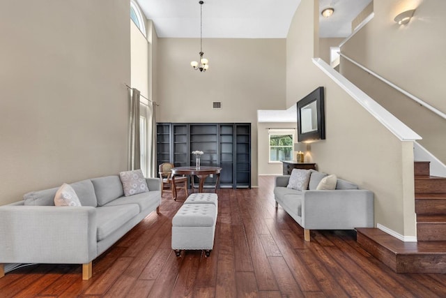 2814 Buckeye Trl, Cedar Park, TX 78613 - living area featuring a towering ceiling, stairway, wood-type flooring, and a chandelier