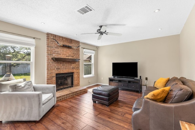 2814 Buckeye Trl, Cedar Park, TX 78613 - living room featuring hardwood / wood-style flooring, a textured ceiling, ceiling fan, a fireplace, and recessed lighting