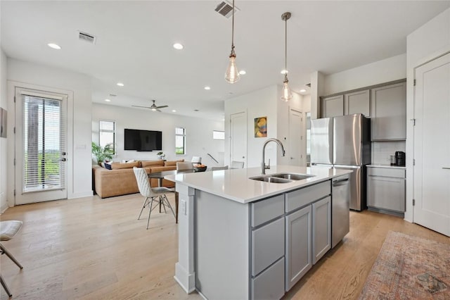 2050 Lohmans Spur Rd Unit 1302, Lakeway, TX 78734 - kitchen with gray cabinetry, a sink, stainless steel appliances, light countertops, and recessed lighting
