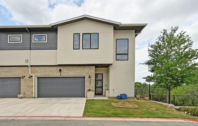 2050 Lohmans Spur Rd Unit 1302, Lakeway, TX 78734 - view of front of property featuring a garage, stone siding, stucco siding, and driveway