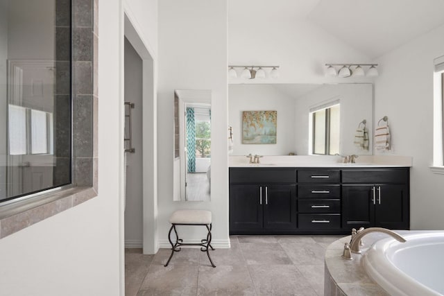 3905 Veneto Cir, Leander, TX 78641 - full bathroom with lofted ceiling, double vanity, and a garden tub