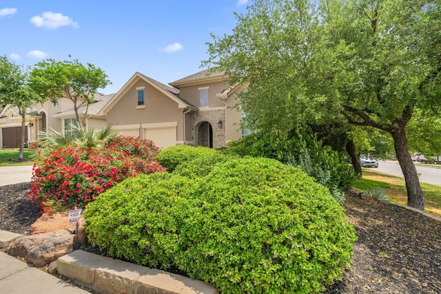 3905 Veneto Cir, Leander, TX 78641 - obstructed view of property featuring stucco siding, stone siding, and an attached garage