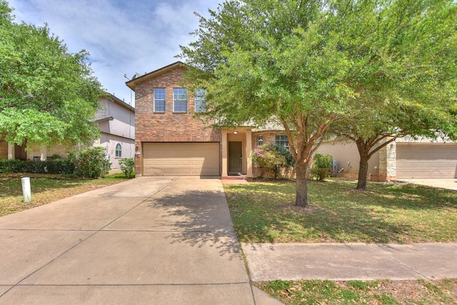 view of front of home featuring a garage, driveway, a front lawn, and brick siding