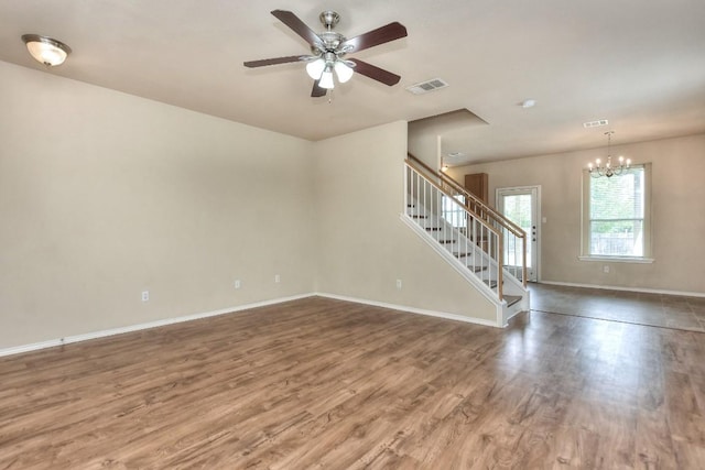 2625 Summerwalk Pl, Round Rock, TX 78665 - unfurnished living room featuring stairway, wood finished floors, a ceiling fan, baseboards, and a chandelier