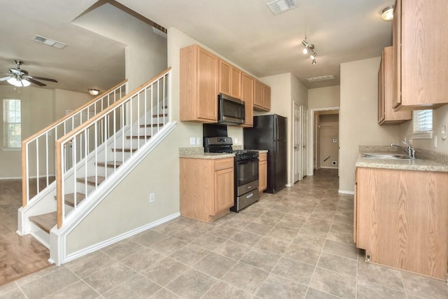 2625 Summerwalk Pl, Round Rock, TX 78665 - kitchen featuring black appliances, a sink, a ceiling fan, light countertops, and baseboards