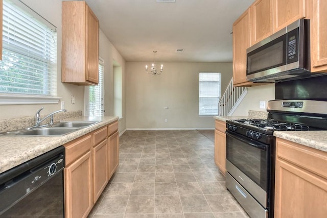 kitchen featuring a sink, light brown cabinetry, a chandelier, light countertops, and appliances with stainless steel finishes
