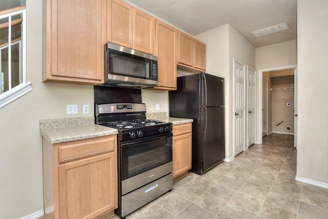 2625 Summerwalk Pl, Round Rock, TX 78665 - kitchen with appliances with stainless steel finishes, light brown cabinets, light countertops, and baseboards