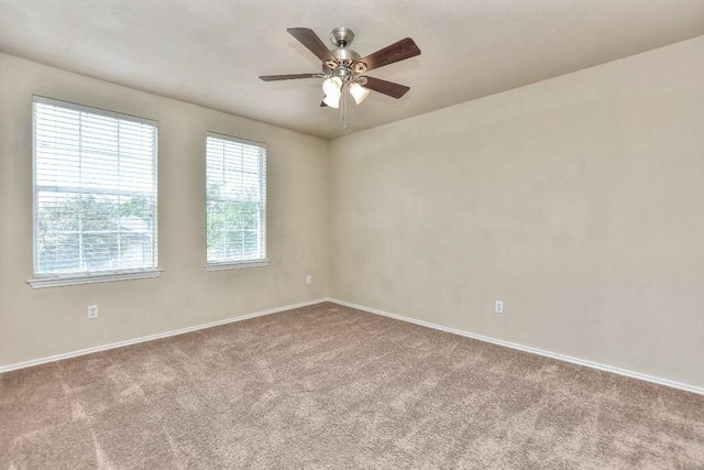 empty room with baseboards, carpet flooring, and ceiling fan