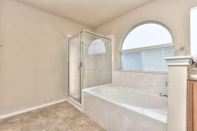 full bath with a shower stall, baseboards, and a bath