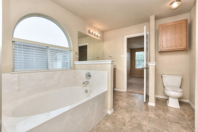 2625 Summerwalk Pl, Round Rock, TX 78665 - full bathroom featuring a garden tub, toilet, baseboards, and tile patterned floors