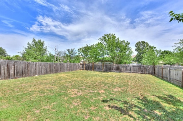view of yard with a fenced backyard