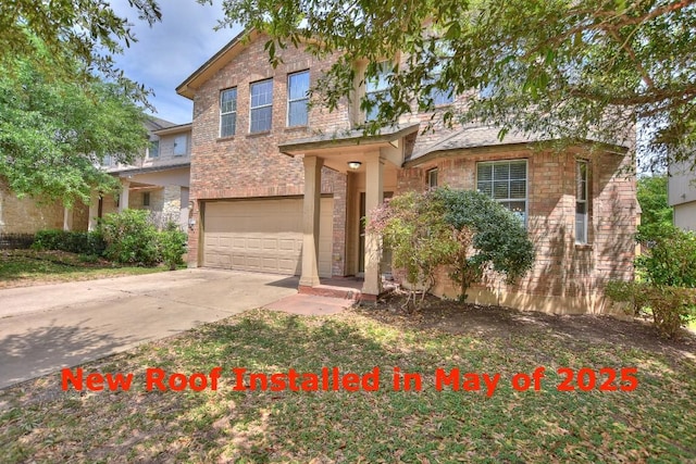 2625 Summerwalk Pl, Round Rock, TX 78665 - traditional-style home featuring an attached garage, concrete driveway, and brick siding