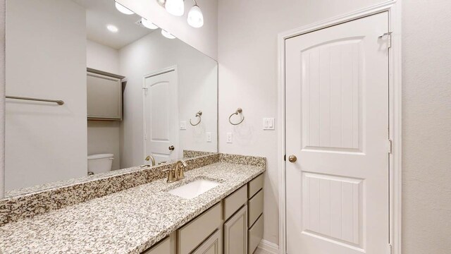 bathroom with toilet and vanity