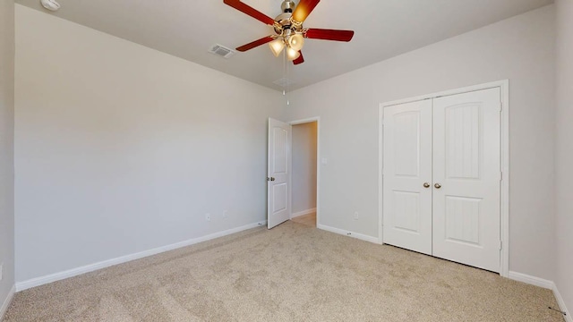 unfurnished bedroom featuring visible vents, a ceiling fan, carpet floors, a closet, and baseboards