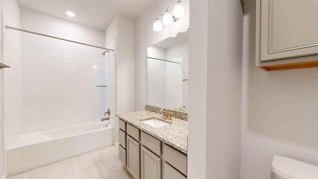 bathroom with toilet, vanity,  shower combination, and recessed lighting
