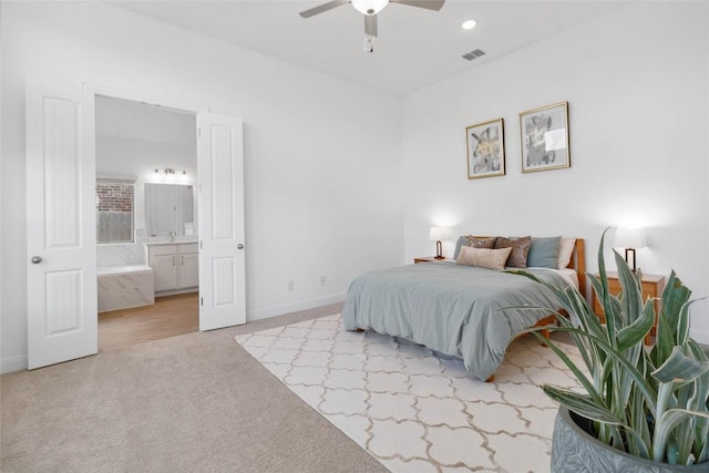 carpeted bedroom with ceiling fan, baseboards, ensuite bath, visible vents, and recessed lighting