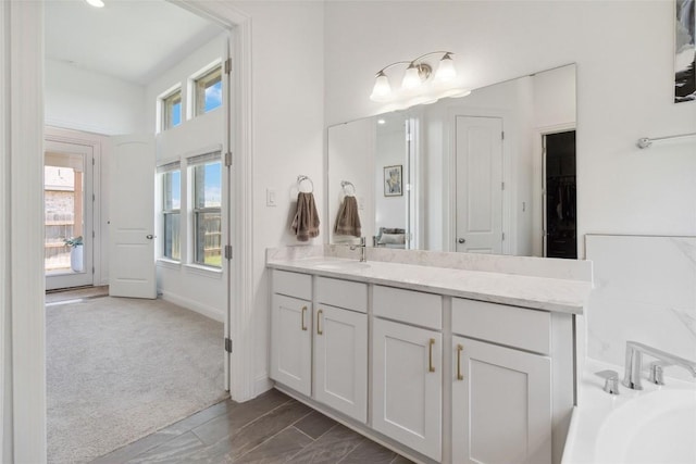 full bath featuring vanity and a bathing tub