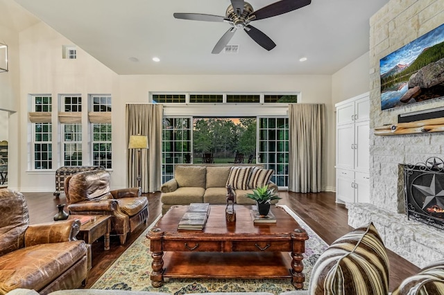 living room featuring a ceiling fan, wood finished floors, a fireplace, visible vents, and recessed lighting