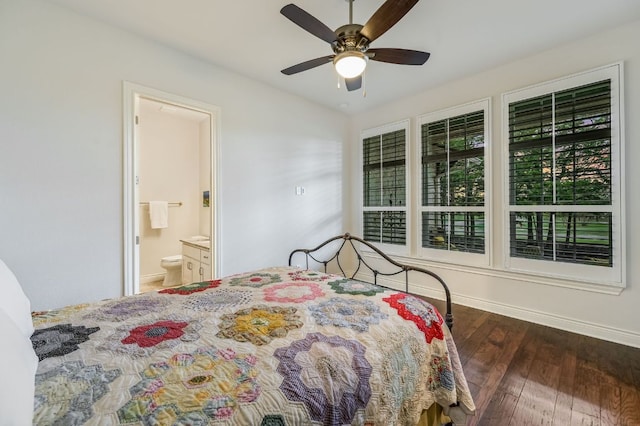 bedroom featuring ensuite bath, baseboards, a ceiling fan, and wood finished floors