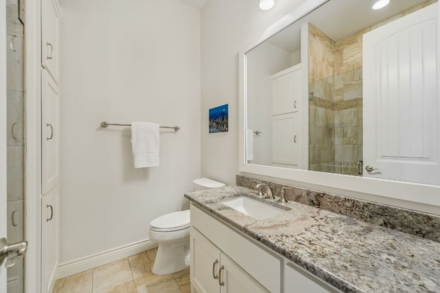 bathroom featuring tiled shower, baseboards, vanity, and toilet