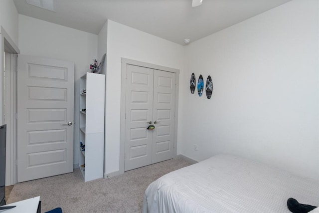 carpeted bedroom with a closet and ceiling fan