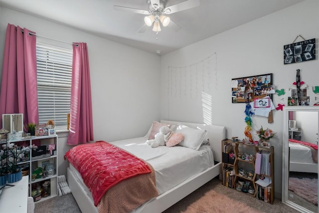 carpeted bedroom featuring ceiling fan and multiple windows