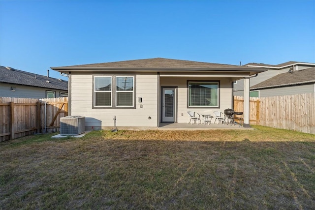 back of house with a fenced backyard, central AC unit, a patio, and a lawn