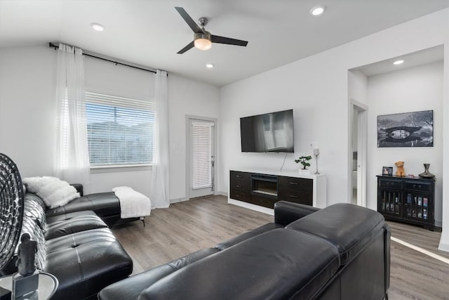 living room featuring baseboards, a ceiling fan, wood finished floors, and recessed lighting