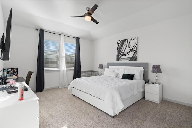 bedroom featuring light carpet, a ceiling fan, and baseboards