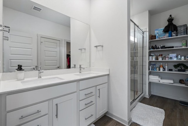 full bath featuring visible vents, a sink, and a stall shower